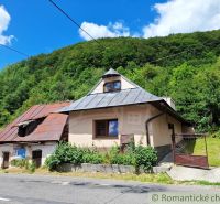 An old house with a sloped roof in Mýto pod Ďumbierom, surrounded by greenery.
