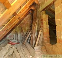 Attic with building materials in a cottage, bricks and wooden beams in Gbelce.