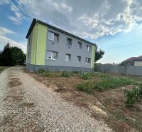 A two-story building with a garden and a road in Telince, suitable for a 2-room apartment.