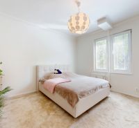 A bright bedroom with a bed, carpeted floor, and a window in a 3-room apartment.