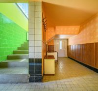 Interior of a family house with tiles, painted walls, and wooden paneling.