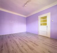 Purple room with a light wooden-patterned floor in a family house.
