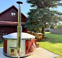 A family house on Jána Švermu Street in Šumiac with a hot tub and a wooden table in the garden.