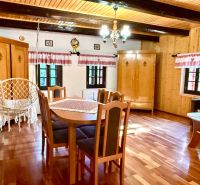 Interior of a family house with a hammock, furniture, and flooring with a wooden decor.