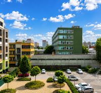 View of the parking lot and surrounding buildings in Bratislava on Nejedlého Street.
