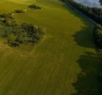 Aerial view of the green plains and forests around Liptovský Trnovec.