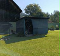 A garden with a wooden cottage and grassy area in Ovčiarsko, suitable for residential land.