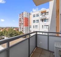 View from the balcony of a 3-room apartment on 1st May Square in Senec, with surrounding houses.