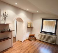 Interior of a family house with an arched entrance and a wooden decor floor.