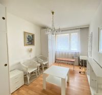Living room with light furniture and wood-patterned flooring in a 4-room apartment.