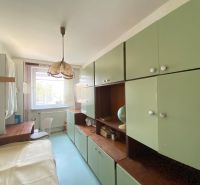 A student room with a massive wardrobe and a desk in a 4-room apartment.