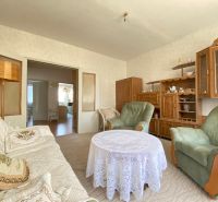 Living room in a 4-room apartment with vintage furniture and a lace tablecloth.