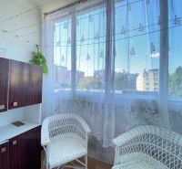 A balcony with knitted chairs and a cabinet in a 4-room apartment.