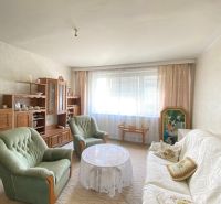 Living room in a 4-room apartment with a sofa, armchairs, and a furniture set.