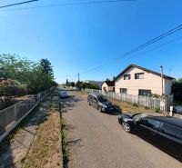 House on Prenosilova Street in Mojmírovce, next to the road with cars and fences.