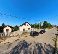 A family house on Prenosilova Street in Mojmírovce with a fence and parked cars in front of the house.