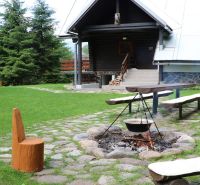 Log cabin in Tále in Brezno with a fire pit and wooden benches as part of hotels and guesthouses.