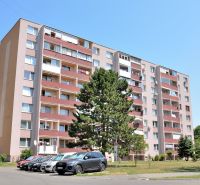 Apartment building with parking and trees on Martina Rázusa Street in Michalovce.