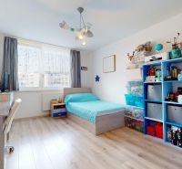 Children's room in a 3-room apartment with a bed, shelves, and a floor with a wooden decor.