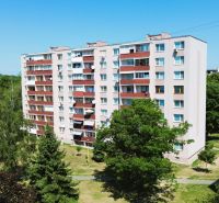 Apartment building with balconies on Martina Rázusa Street, Michalovce, surrounded by greenery.
