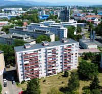 Aerial view of apartment buildings on Martina Rázusa Street in Michalovce, surrounded by greenery.