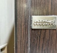 Detail of ADLO security door in a 3-room apartment, floor with wood decor.