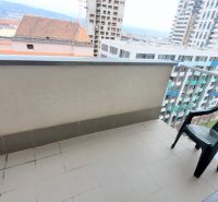 Balcony of a 2-room apartment on Jégého in Bratislava - Ružinov with a plastic chair.