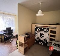 A children's room in a two-room apartment with a bunk bed and a work corner.
