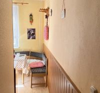 A cozy corner in a 2-room apartment with a wooden decor floor and colorful decorations.