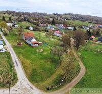 The rural landscape around a family house in the village of Volica, visible road and meadow.