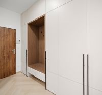 Built-in wardrobes with seating area and flooring with wood decor in a 4-room apartment.