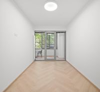 A room with a wooden decor floor and large glass doors in a 4-room apartment.