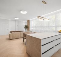 Living room in a 4-room apartment with a wooden decor floor and large windows.