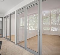 Glazed walls and a floor with a wooden decor in a 4-room apartment.