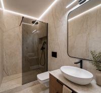 Bathroom in a 4-room apartment with a large mirror, sink, and shower stall.