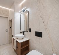 A bathroom in a 4-room apartment with marble tiles and a high-quality sink.