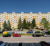 Housing estate with panel buildings and cars on the street of the May Uprising of the Czech People in Brezno.