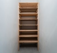 Wooden shelf in a narrow room, typical for a 2-room apartment.