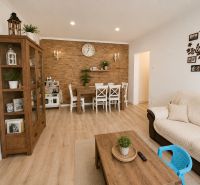 Interior of a 3-room apartment with a wooden decor floor and white furniture.