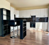 A kitchen corner with a bar and a wooden decor floor in a 2-room apartment.