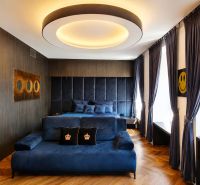 Luxury room with blue furniture, wood-patterned flooring, and a large window.