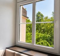 A bright room with comfortable seating and a large window, 2-room apartment.