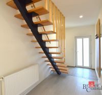 A staircase with a wooden decor floor, entrance, and radiator in a 2-room apartment.