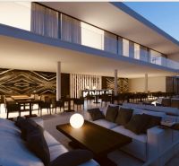 Elegant terrace with comfortable seating and a decorative wall in the restaurant area of commercial properties.