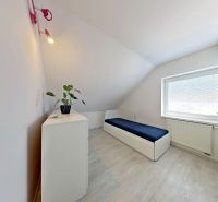 A room in a 3-room apartment with a wooden decor floor and white walls.