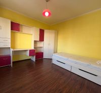Children's room in a 3-room apartment with yellow walls and furniture with storage space.