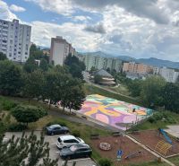 A view of the colorful playground, play area, and apartment buildings on Mateja Bela in Trenčín.