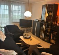 Living room in a 3-room apartment with comfortable seating and a floor lamp.