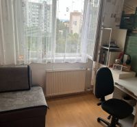 A work corner in a 3-room apartment with a wooden decor floor and a writing desk.