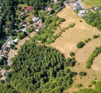 Aerial view of plots - housing in Banská Štiavnica, Obrancov mieru surrounded by forests and houses.